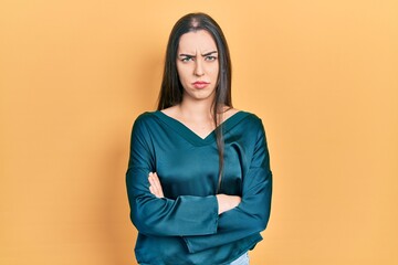 Beautiful woman with blue eyes wearing elegant shirt skeptic and nervous, disapproving expression on face with crossed arms. negative person.