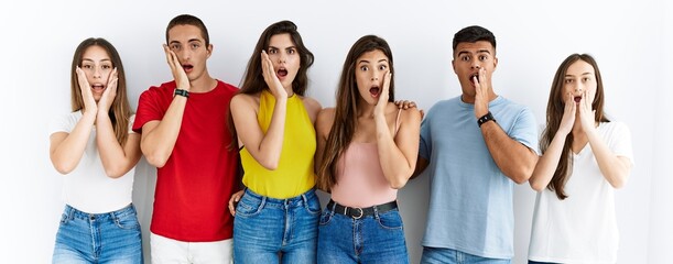 Group of people wearing casual clothes standing over isolated background afraid and shocked,...