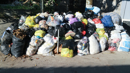 pile of dirty trash on the side of the road