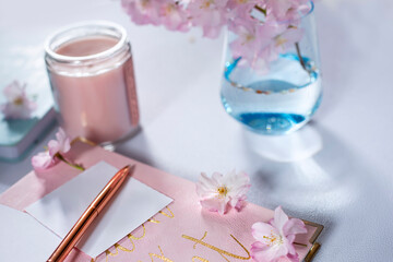 notebooks for notes and delicate spring flowers. lovely soft colors. Selective focus.
