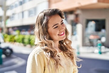 Young woman smiling confident looking to the side at street