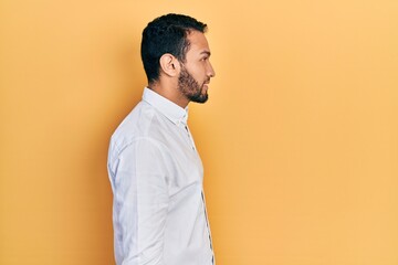 Hispanic man with beard wearing business shirt looking to side, relax profile pose with natural...