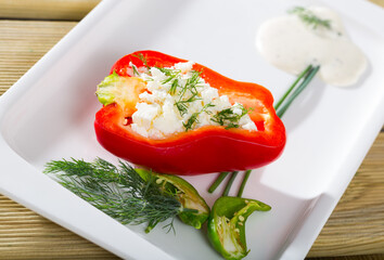 Photography of plate with pepper stuffed with brynza in restaurant.