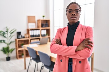 African american woman business worker standing with arms crossed gesture at office