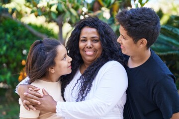 African american family hugging each other at park