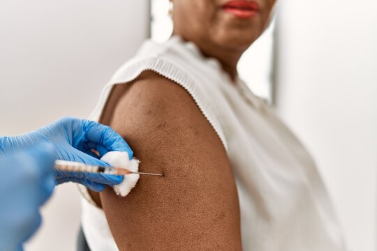 Senior african american woman patient having vaccination at clinic