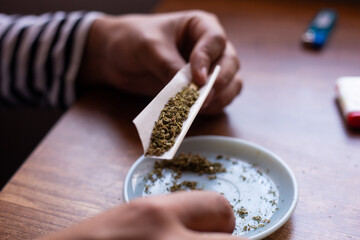 manos armando un blunt de marihuana (Cannabis). Concepto de medicina natural.