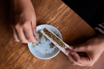 manos armando un blunt de marihuana (Cannabis). Concepto de medicina natural. © artrolopzimages