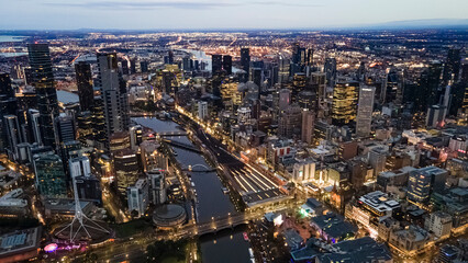 Naklejka na ściany i meble Aerial drone view of Melbourne City, Victoria, Australia looking in the direction of Port Phillip above Yarra River in the early morning at dawn 