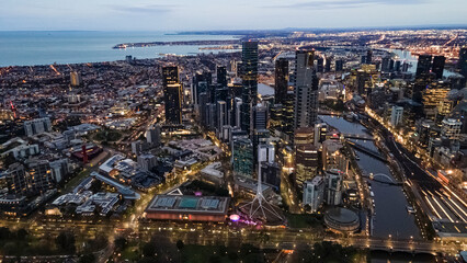 Fototapeta na wymiar Aerial drone view of Melbourne City, Victoria, Australia looking in the direction of Port Phillip above Yarra River in the early morning at dawn 