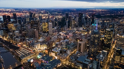 Fototapeta na wymiar Aerial drone view of Melbourne City, Victoria, Australia looking in the direction of Port Phillip above Yarra River in the early morning at dawn 