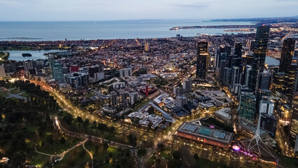 Aerial drone view of Melbourne City, Victoria, Australia looking in the direction of Port Phillip above Yarra River in the early morning at dawn 