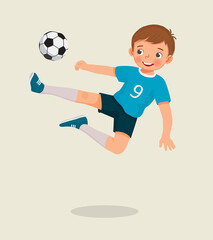 cute little boy playing soccer jumping high kicking the football to make a goal