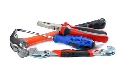 Screwdriver, wrench, pliers and hammer isolated on white background.