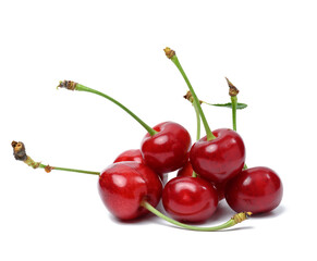 Ripe red cherry on a white isolated background.