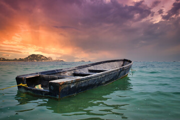 boat on the beach at sunset