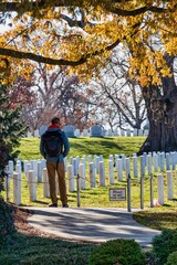 person walking in autumn in cementery