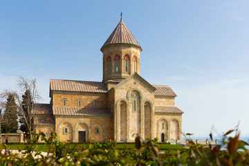 Fototapeta na wymiar Scenic spring view of Church of St. Nino in Bodbe nunnery, popular pilgrimage site among Orthodox Christians, Kakheti, Georgia