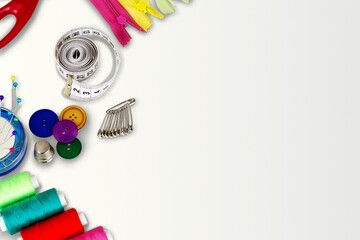 Skeins of sewing thread, multicolored buttons, scissors, needles, thimble, zipper. The concept of manual labor,clothing repair,sewing,embroidery,sale of sewing accessories