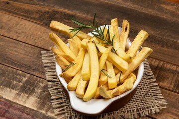 Tasty french fries on plate on bowl