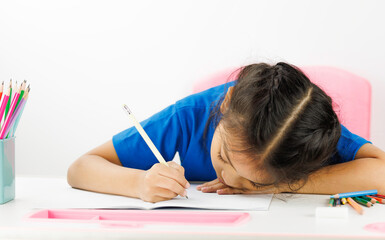 child girls sleeping while doing homework writing and reading at home