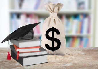 Saving money for college tuition fees, education concept, bags, a black graduation cap, a...