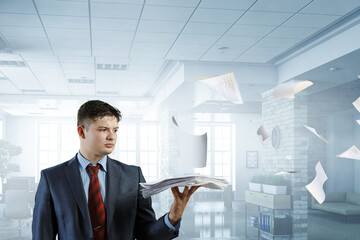 Fototapeta premium Business Concept - handsome young professional businessman holding report papers