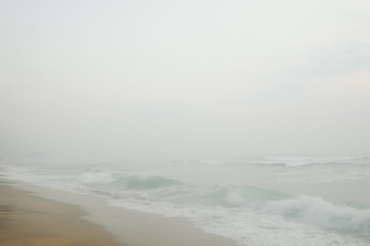 Seascape abstract beach background with misty. sea surf with fog. Image soft look with smooth technique.