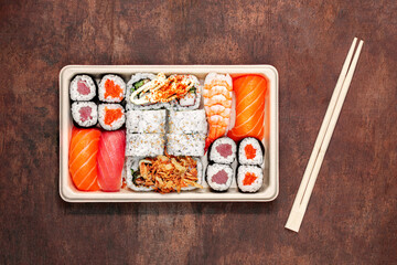 Sushi set with rice, salmon  and shrimps on wooden table, top view. Japan restaurant menu.
