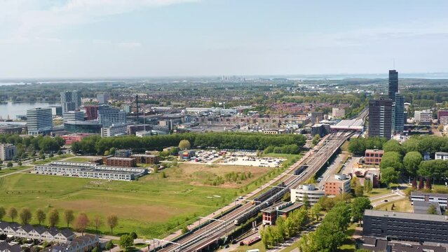 Almere city center (Almere Stad),  Flevoland, The Netherlands. Modern, growing suburban town near Amsterdam. Train station, railroad. Aerial drone shot.