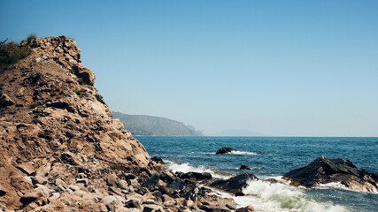 The sea and rocks on the south coast. Crimea, a landscape on a sunny day. Front view.