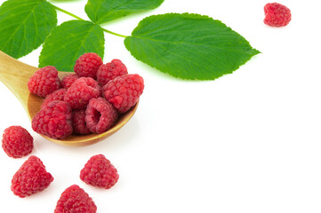 Several ripe red raspberries in a wooden spoon