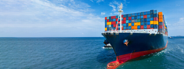 In Front View of large cargo ship import export container box on the ocean sea on blue sky back...