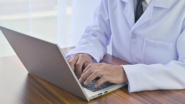 Doctor working with computer notebook in hospital office, Healthy medical concept
