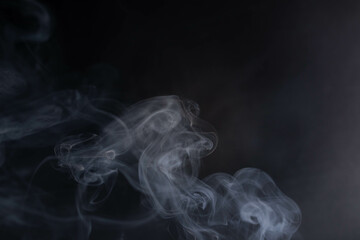 frankincense with white smoke on black background