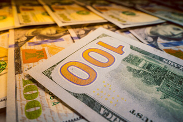 The number one hundred on the back of a beautiful new one hundred dollar bill close-up