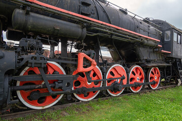 Fototapeta na wymiar An old steam locomotive rests on the siding.