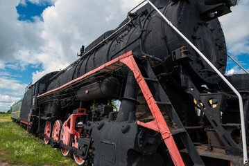 An old steam locomotive rests on the siding.