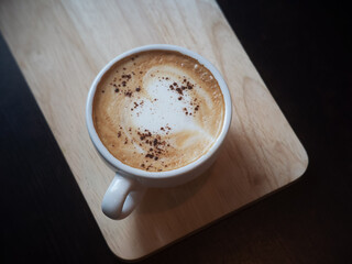 White cup of tasty cappuccino with love art latte