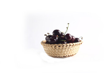 a bowl of black cherry isolated on white background