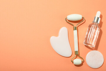 Face care concept with gua sha, face roller and cosmetic