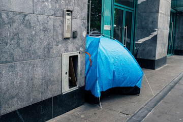 Blue tent in town center street for homeless. Living in a hard conditions due to economy problems...