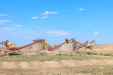 Fototapeta premium a sand pit with an excavator and full equipment. 