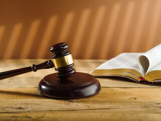 Judgment and Justice. Judge's wooden gavel and Constitution book on a beige background. Rule of law, court.