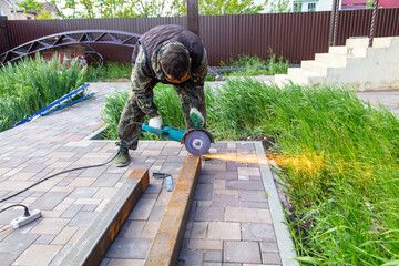 A worker cuts metal at a construction site.