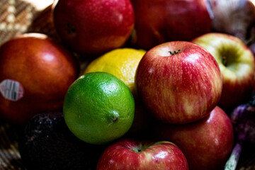 apples, lemon and lime in a basket close up