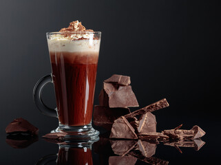Hot chocolate with whipped cream and pieces of dark chocolate.