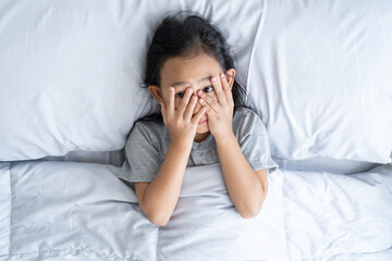 Top view asian child little girl was scared before going to bed
