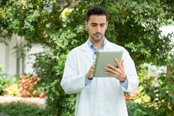 Portrait of a biologist with a tablet in a greenhouse