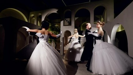 Beautiful men and women in vintage fluffy dresses waltz